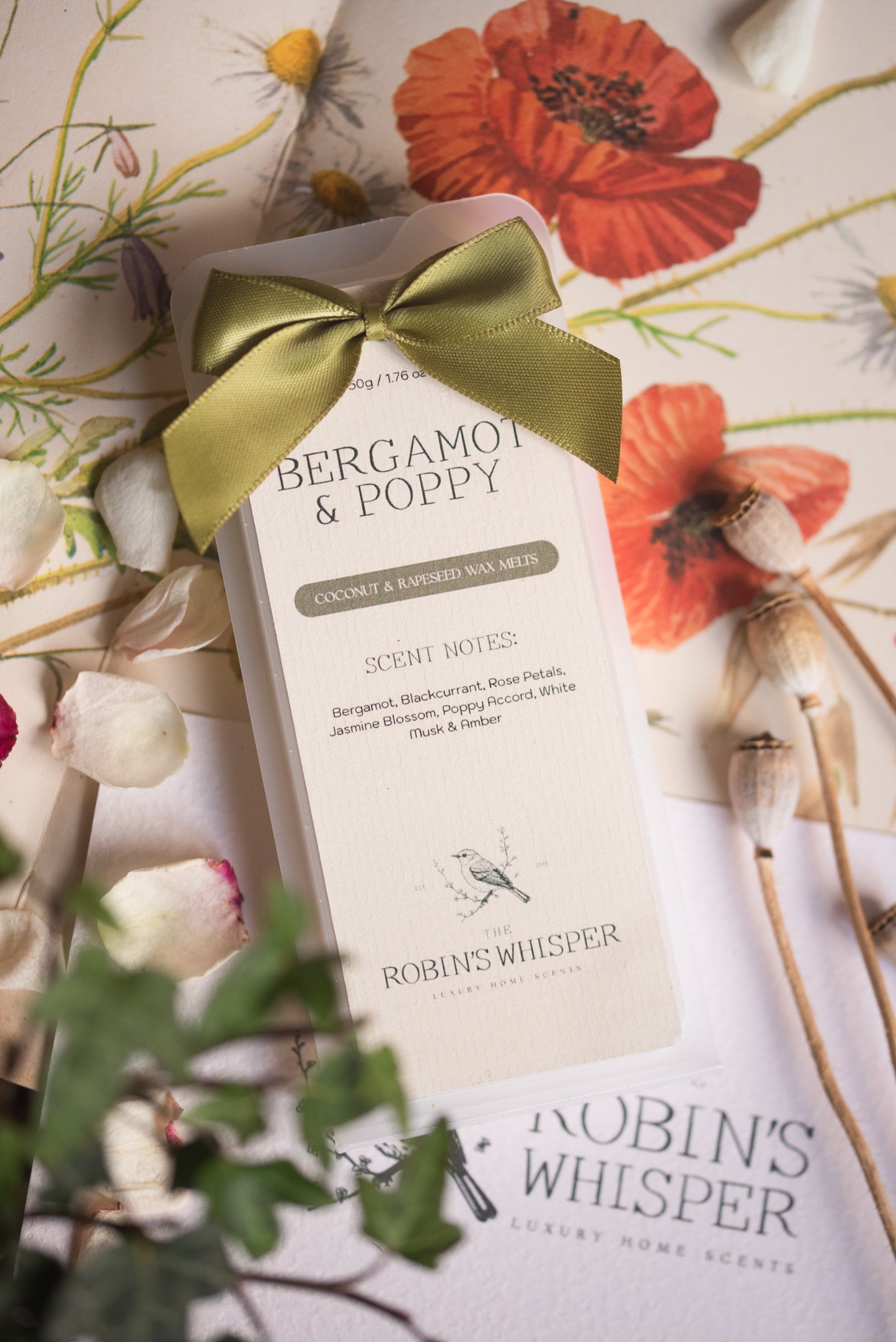 Product packaging with a green ribbon on a floral background