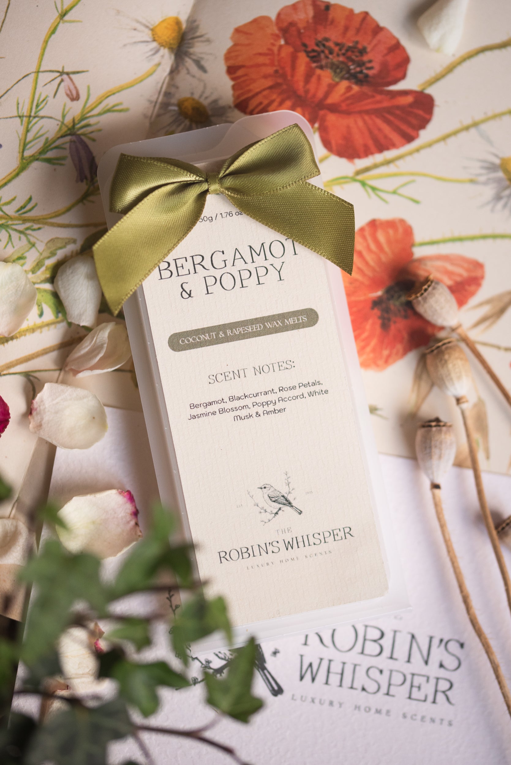 Product packaging with a green ribbon on a floral background
